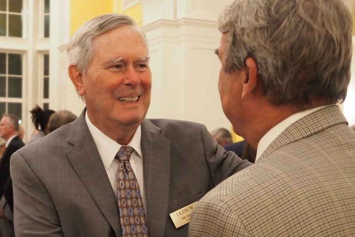 Tim Ubben '58 greets a man at a Campaign for DePauw function.