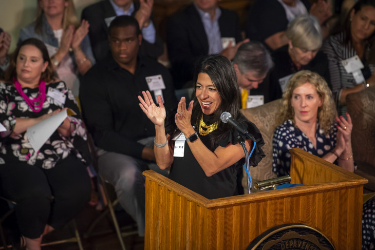 Alumni Association Board of Directors clapping on-stage during convocation