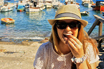 Megan Crowley eating next to the water during her study abroad trip