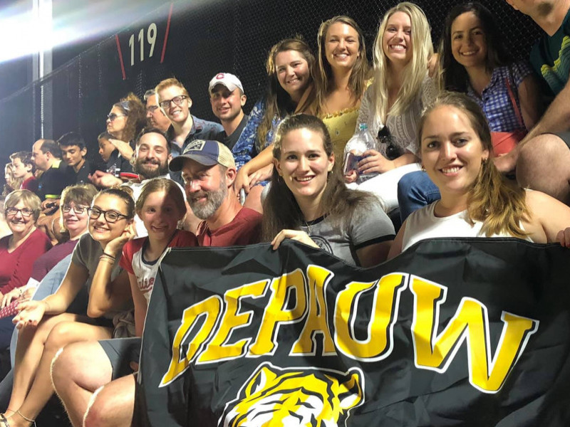 fans in bleachers holding depauw flag