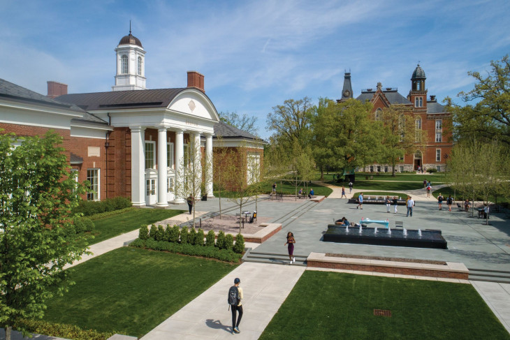 Students walk on sidewalk across campus