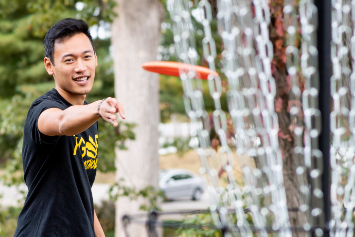 Student plays disc golf