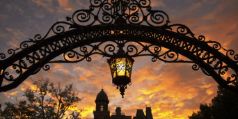 Archway entrance with sun setting behind East College