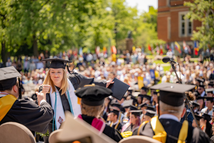 Students, staff, and faculty in front of the Emison building during commencement