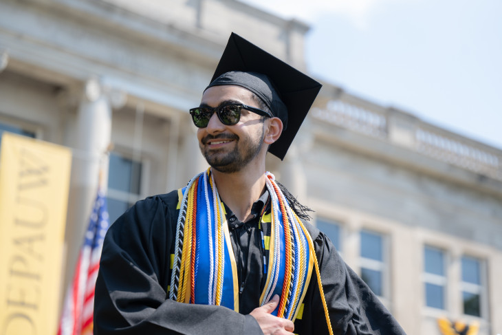 Student receives diploma during commencement