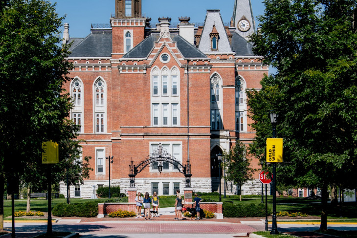 Students standing with East College in the background