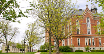 Students sitting on East College lawn