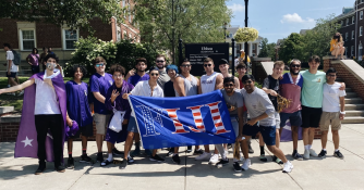 Students posing with a banner