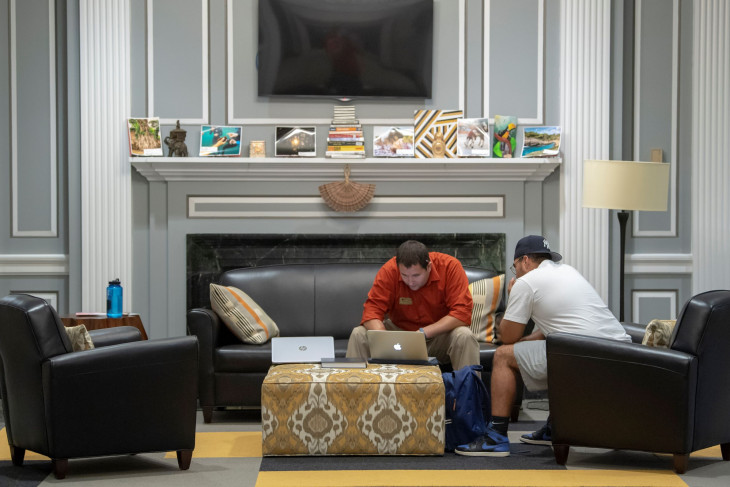 Students sit in front of the fireplace in the Hubbard Center