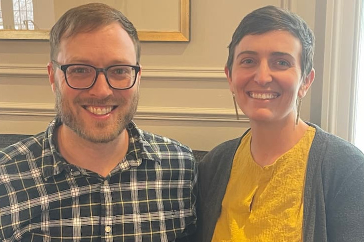 male and female sitting on couch