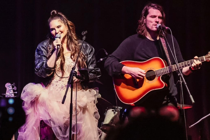 male and female on stage singing