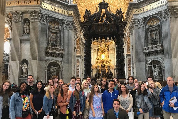 A group of approximately 20 students standing with Professor Micheal Seaman in St Peter's Basilica in Rome. 