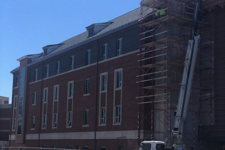 Outside photo showing work on the exterior of residence hall 1