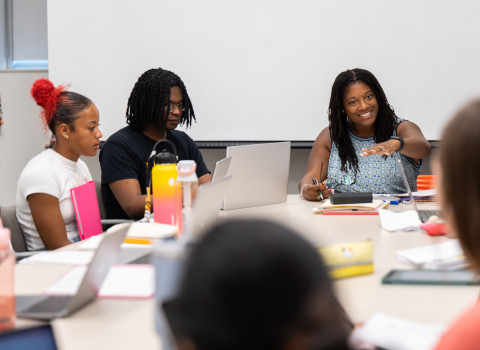 Karin Wimbley having a discussion with students at a table