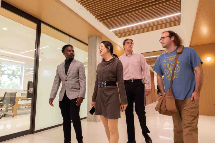 A group of students walk through Harrison Hall
