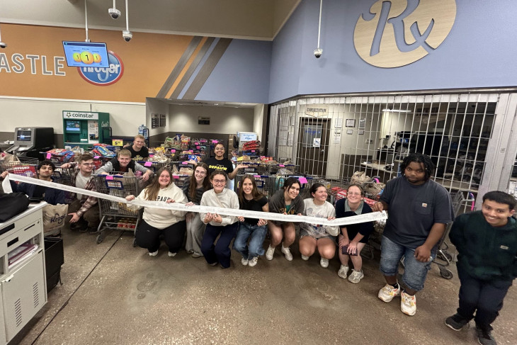 Students with carts full of donated grocery supplies