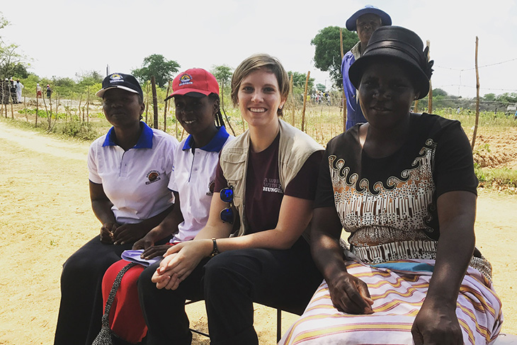 Ashley Baxstrom, third from left, between locals in Zimbabwe.