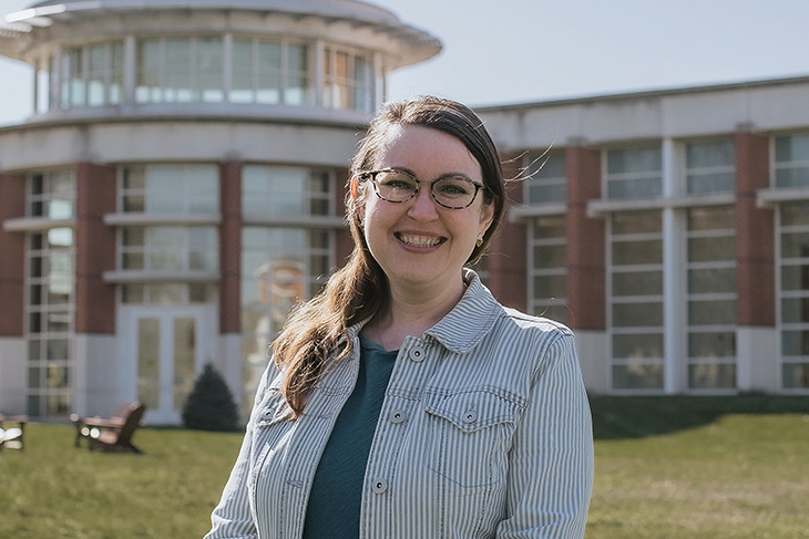 Elissa Harbert standing in front of the Green Center for Performing Arts on a sunny day