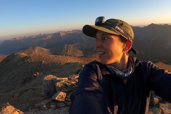 Micah Ling hiking with a backdrop of canyons