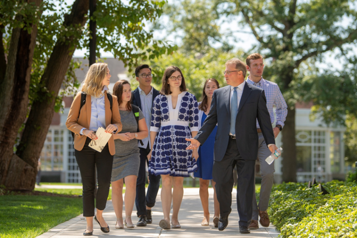 Students and staff walking across campus