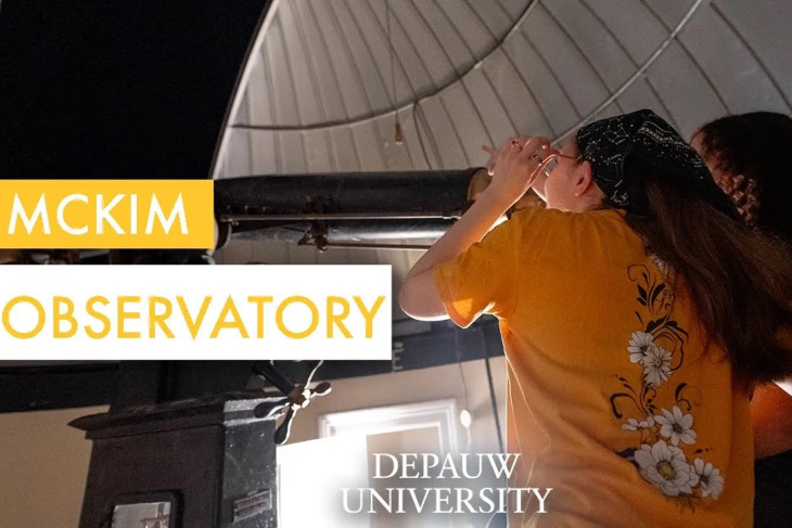 Video still of students looking through telescope