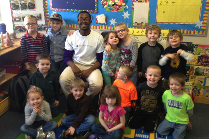A DePauw student volunteering with children in a local elementary school classroom.