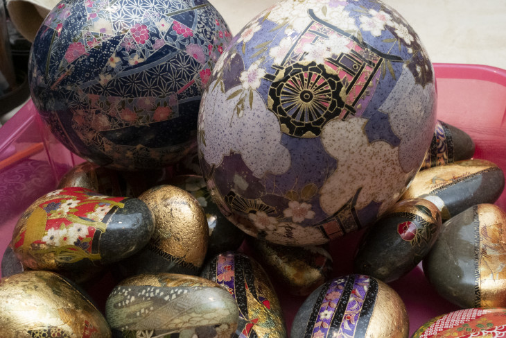 Rocks covered in Japanese paper to make paperweights.