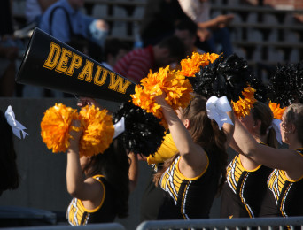 Cheerleaders firing up the crowd during a football game
