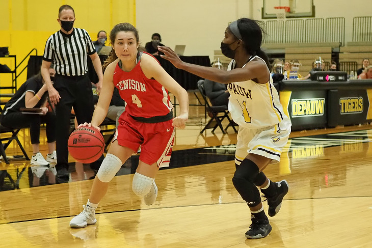 Masked DePauw basketball player guards opponent