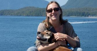 Nichole Pacino with a dog and lake background