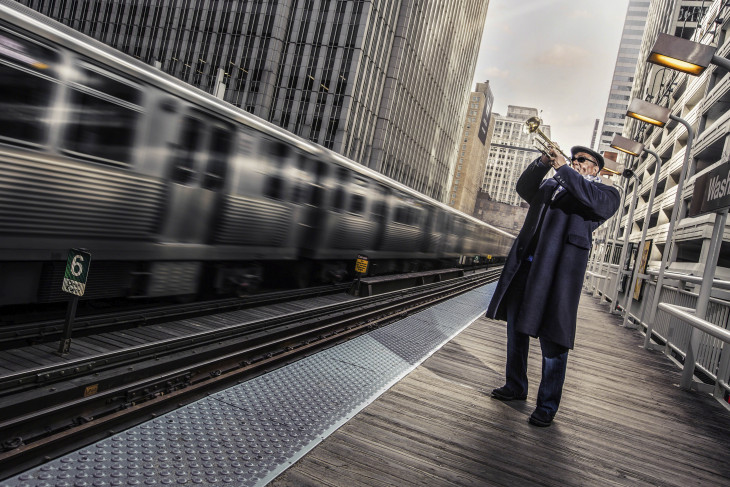 Trumpeter Pharez Whitted plays on the El platform in Chicago.