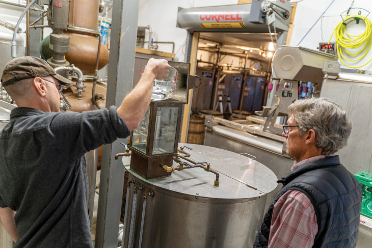 Pogue family pouring liquid into machine