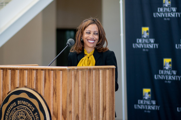 President White stands at a lectern during her official welcome to campus.