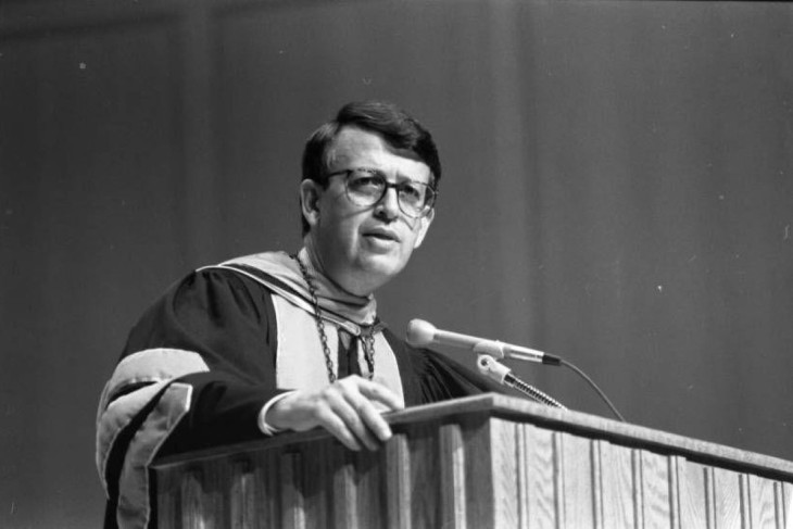 President Bottoms speaks at lectern in academic regalia
