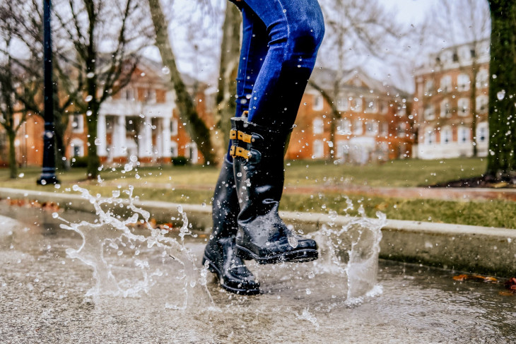 Water splashing as a woman skips through it