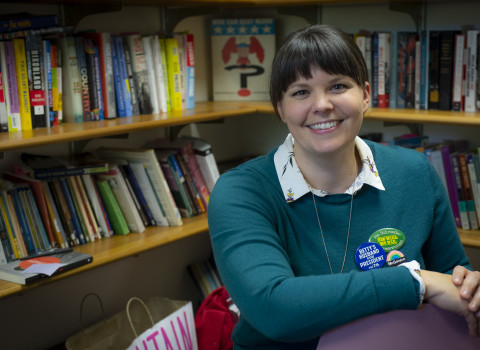 Sarah Rowley sitting in an office with books in the background