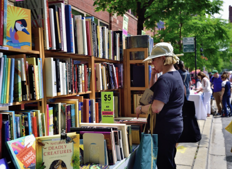 A woman ponders making a purchase at the Printers Row Lit Fest in Chicago. (Bruce Leighty /Alamy Stock Photo)