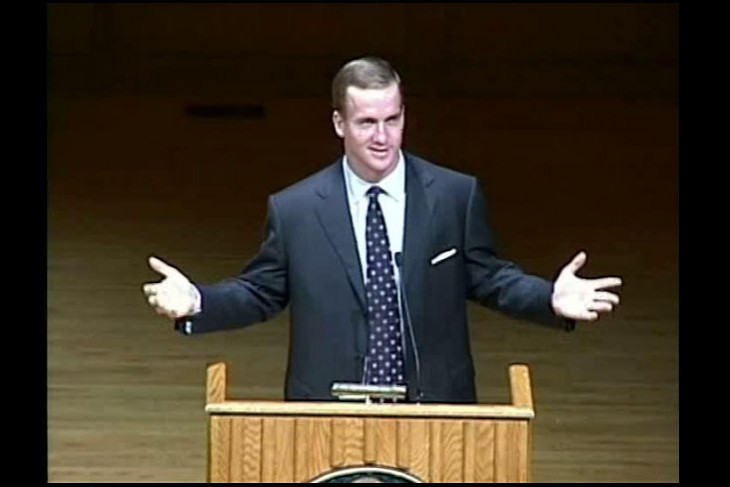 Peyton Manning with arms outstretched during an Ubben Lecture