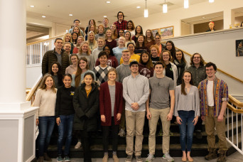 Students posing on the staircase in the Student Union Building