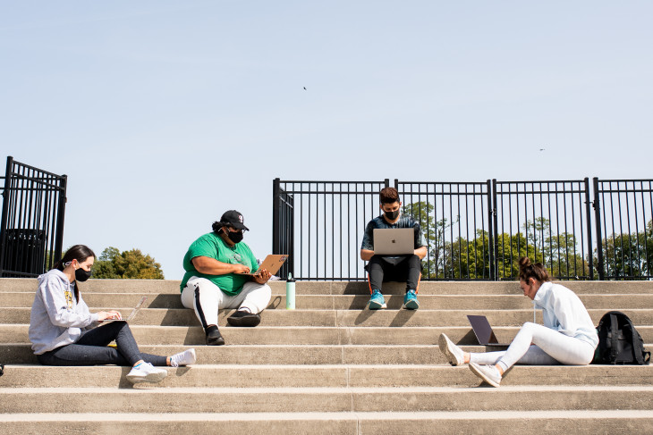 Socially distanced students study outside