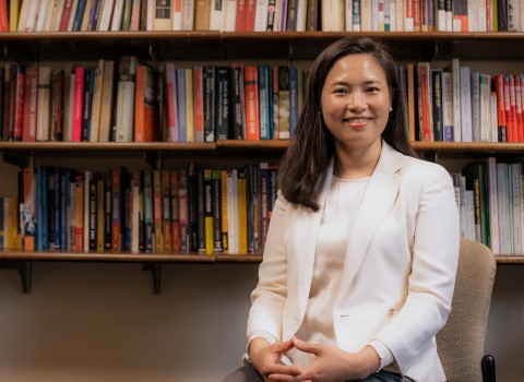 Prof. Sujung Kim in her office with books in the background