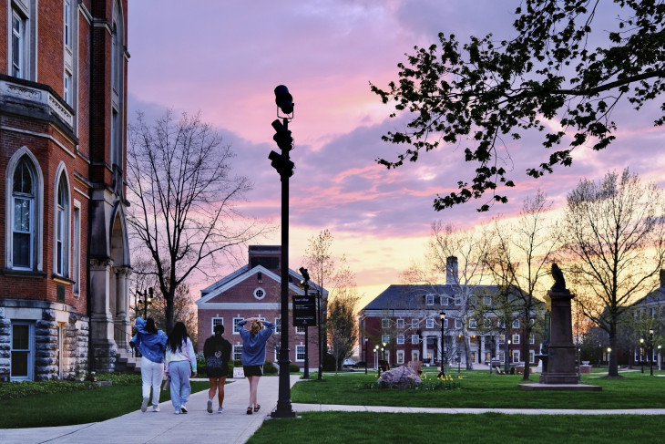 Sunset on campus with four women walking. 
