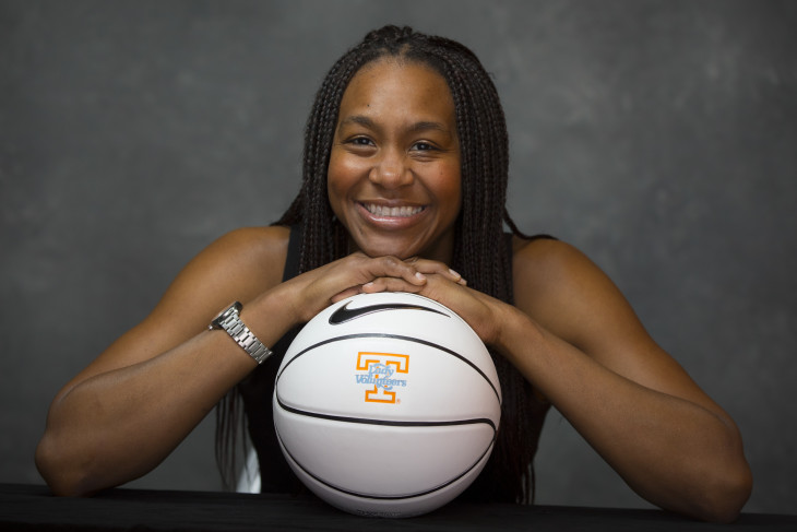 Basketball star Tamika Catchings leans on a basketball