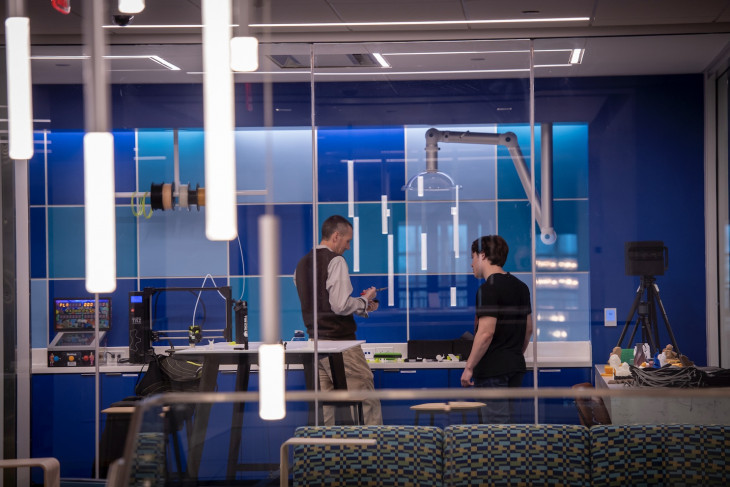 Michael Boyles and a student work in the Tenzer Technology Center's new 3D printer makerspace.