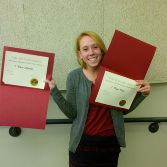 Erin Mann flashes her awards after her successful first collegiate debate tournament at Ball State University (2014).