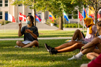 Students sitting outside during new student welcome session
