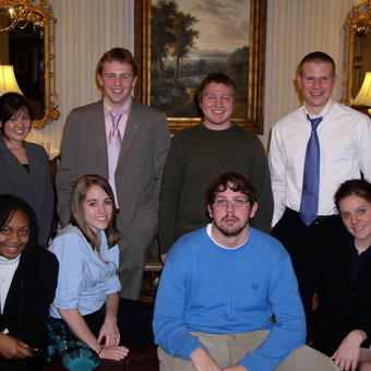 Brittney Belcher, Nikki Miyasato, Jessica Hawkins, Avery Archer, Aaron Dicker, Kevin Milne, Michael Lutz, and Keelin Kelly (left to right) are dressed for Success at the 2008 Pi Kappa Delta National tournament.