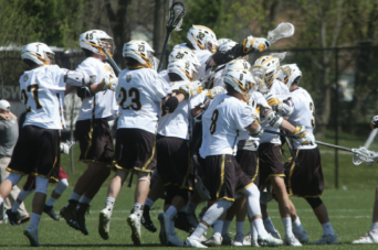 Lacrosse team celebrates a goal