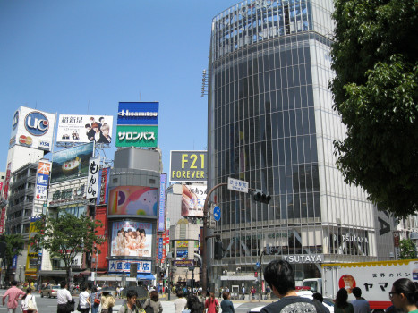 There are many high buildings in Shibuya, Tokyo and people are crowding the streets