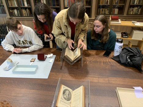 1 Perusing the first edition of Robinson Crusoe, with Gulliver feeling out of place.